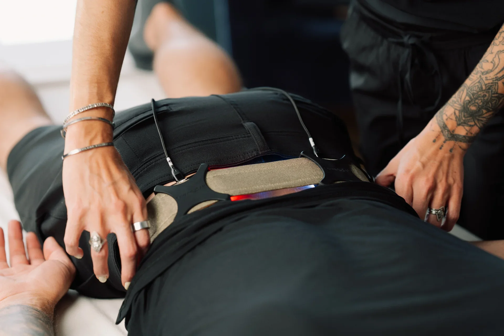 Physical therapist using AI-powered wearable device analyzing patient mobility in a modern clinical setting