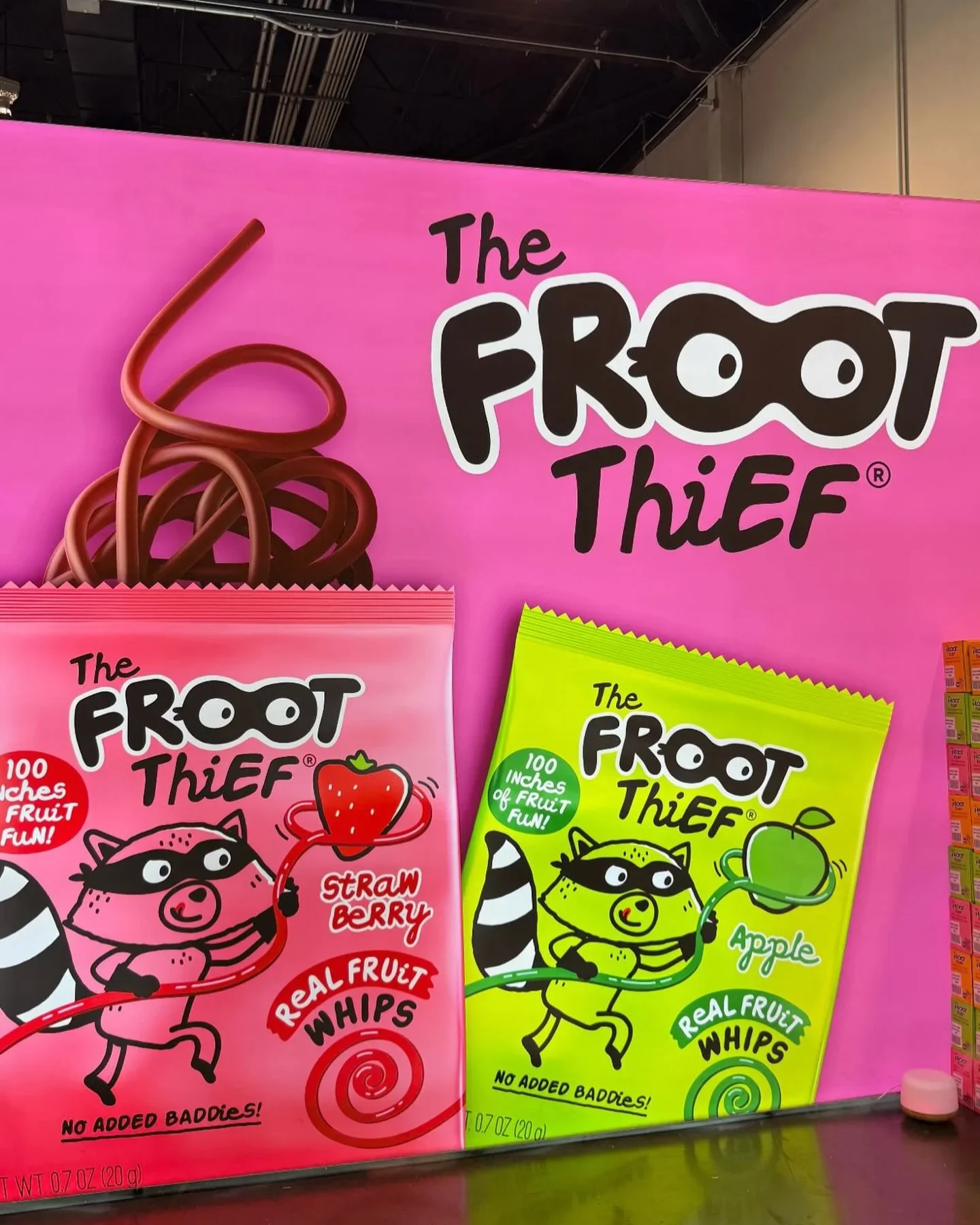 eco-friendly snack packaging on rustic wooden surface surrounded by fresh fruits and greenery